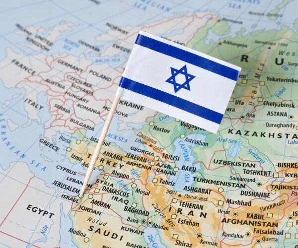 israel paper flag pin on a map