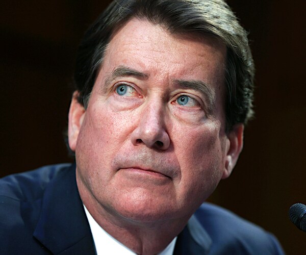 bill hagerty looks over his left shoulder during a senate hearing