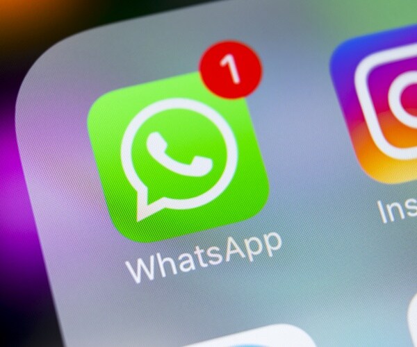 WhatsApp messenger application icon on Apple iPhone X smartphone screen