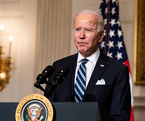 joe biden speaks into microphone