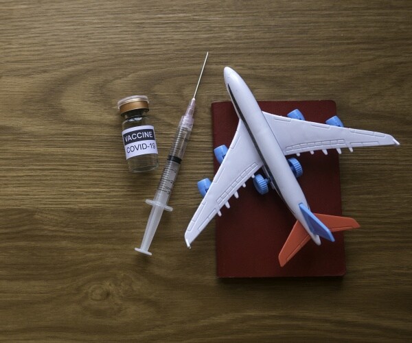 image of model airplane, syringe, passport