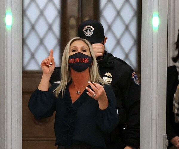 Marjorie Taylor Greene, R-Ga., yells at journalists after setting off the metal detector outside the doors to the House