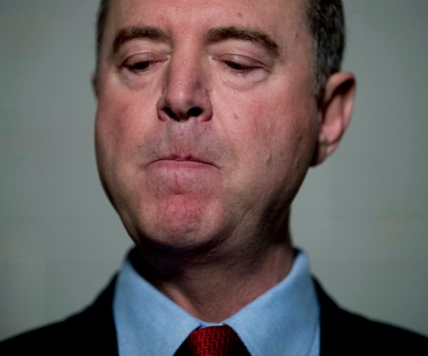 Adam Schiff looks on