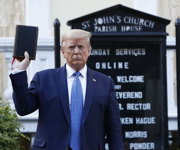 donald trump holds a Bible as he visits outside St. John's Church across lafayette park from the white house 