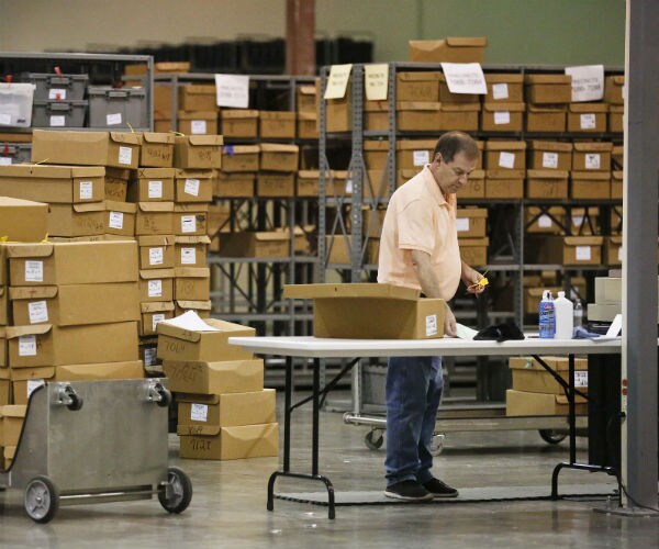 an employee at the palm beach county supervisor of elections office with ballots