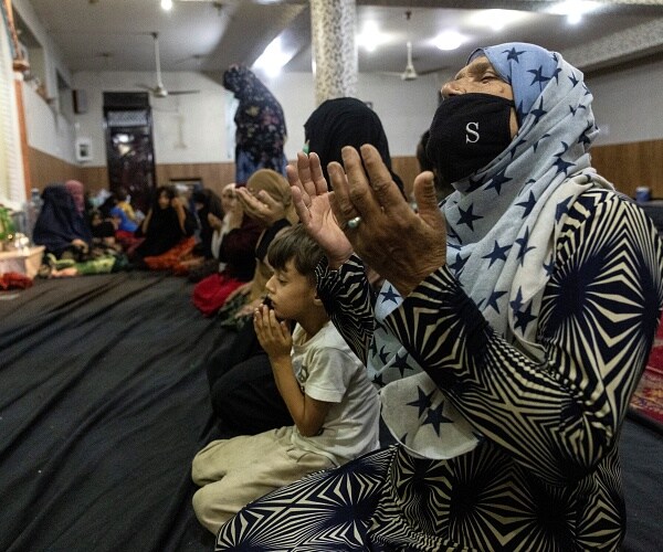 women and children pray in mosque