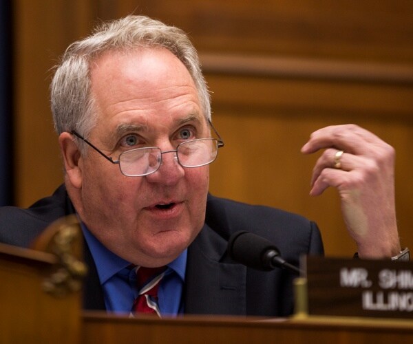 john shimkus sits behind desk