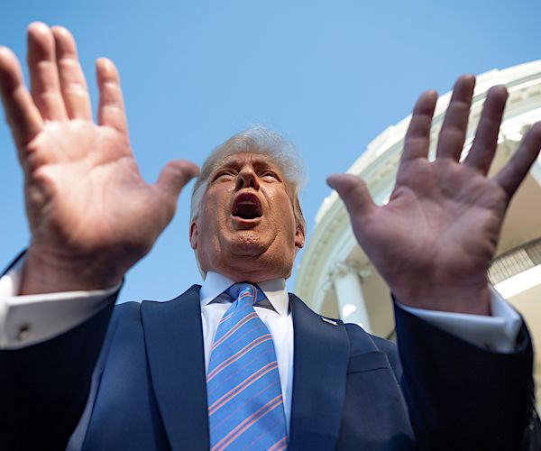 president donald trump gestures with both hands during a white house driveway media scrum