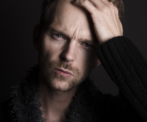 man looking at camera looking anxious and depressed