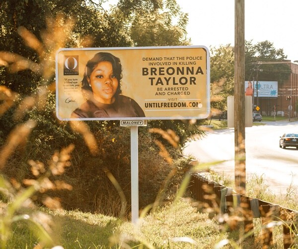 a billboard on the road highlights the death of breonna taylor