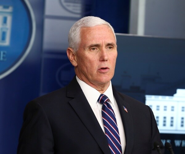 pence in a suit and striped blue red and white tie