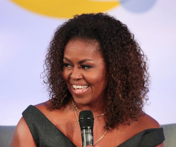 Former first lady Michelle Obama speaks to guests at the Obama Foundation Summit.