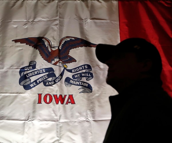 a supporter walks across a sign in iowa