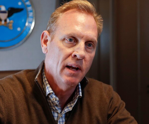 patrick shanahan speaks to the media aboard a defense department plane