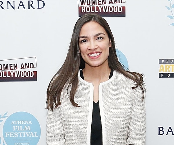 alexandria ocasio-cortez smiles for camera