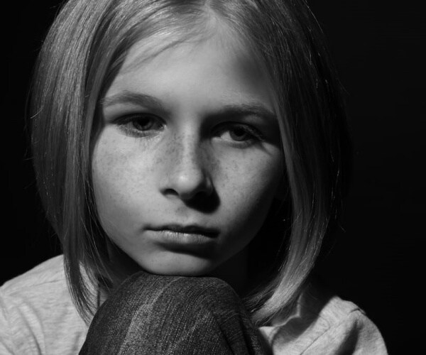 young girl looking sad, pensive