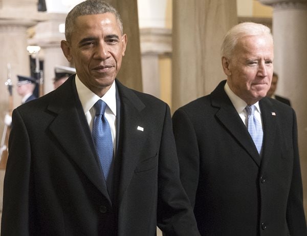 barack obama and joe biden walk with smug smiles