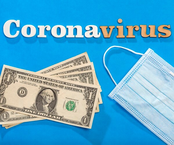 coronavirus phrase text on a blue background with protective mask and paper money