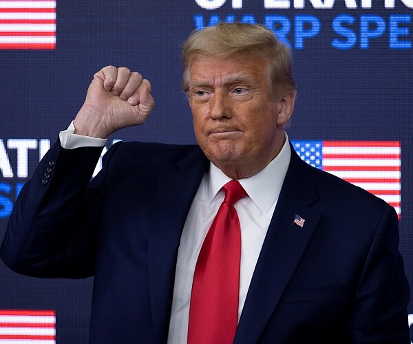 donald trump holds up fist