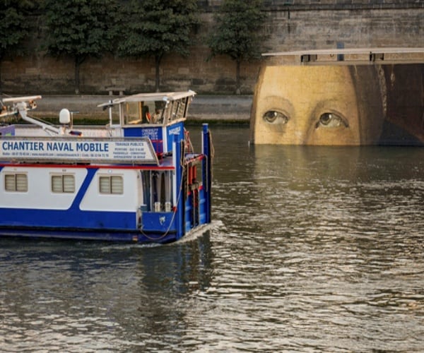 the Seine River in Paris with Mona Lisa billboard and a boat