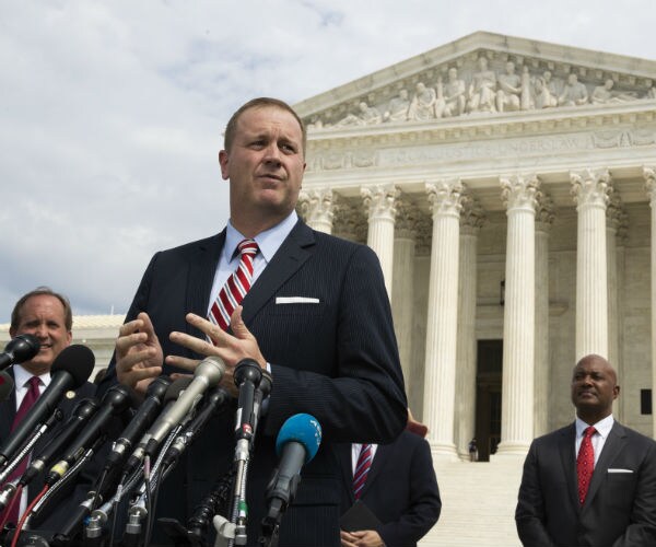 missouri ag eric schmitt in full suit speaks to reporters