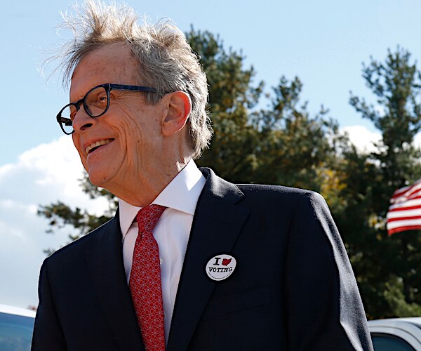 mike dewine smiles as he walks outdoors