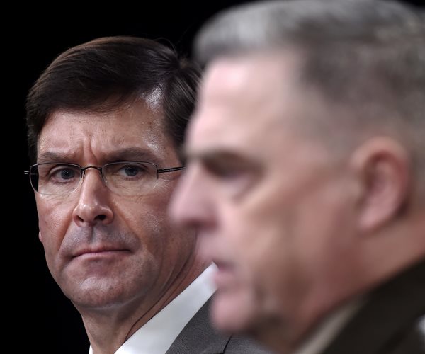 mark esper looks toward camera as he stands behind gen.mark milley