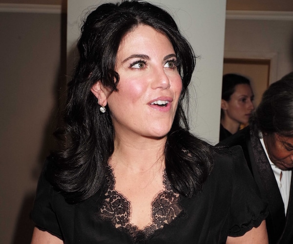 monica lewinsky smiles walking out of a meeting