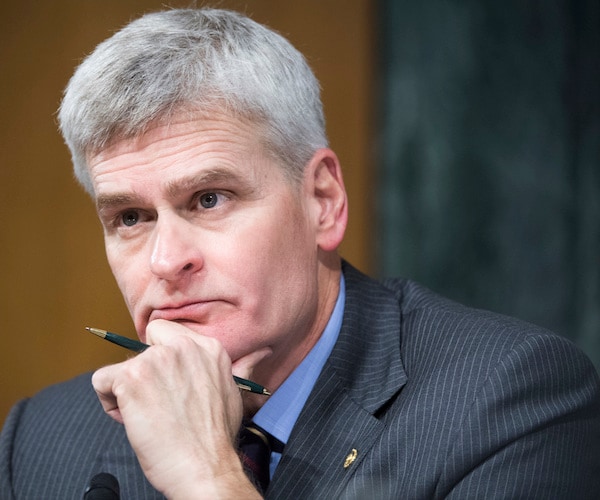 bill cassidy rests his chin in his hands during senate testimony