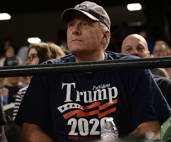 curt schilling wears a trump 2020 shirt and sits in the bleachers of a baseball game