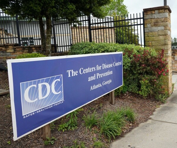 blue sign outside cdc headquarters in atlanta