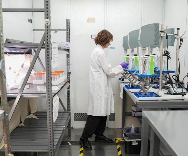 scientists in lab testing water