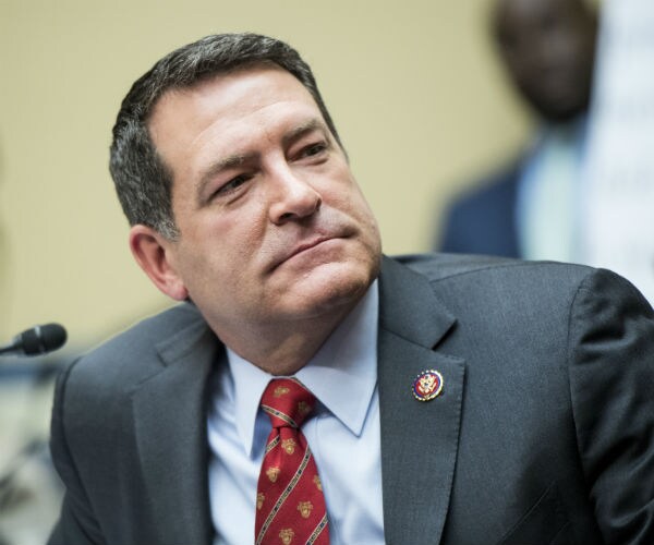 rep. mark green is shown listening in a hearing on capitol hill