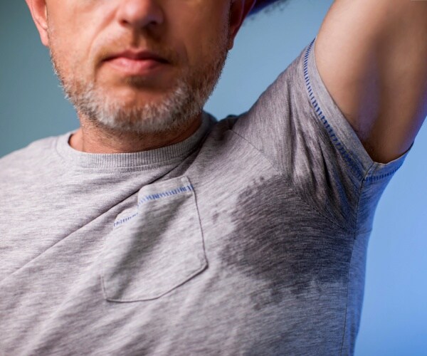 man in t-shirt with sweat under armpits