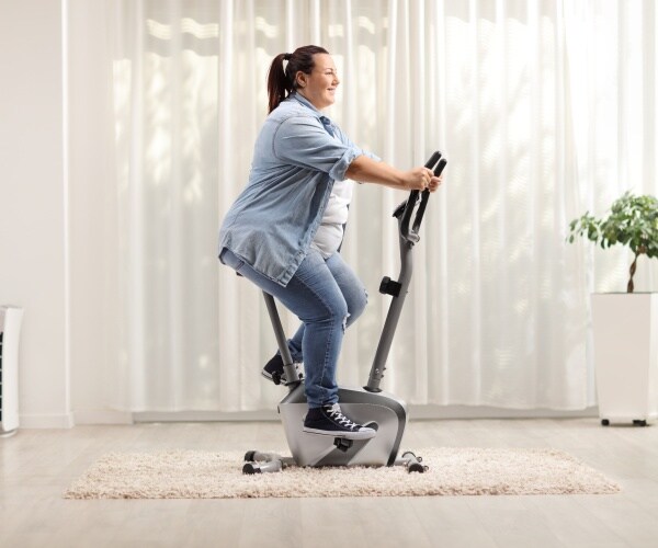 a woman on exercise machine in her home