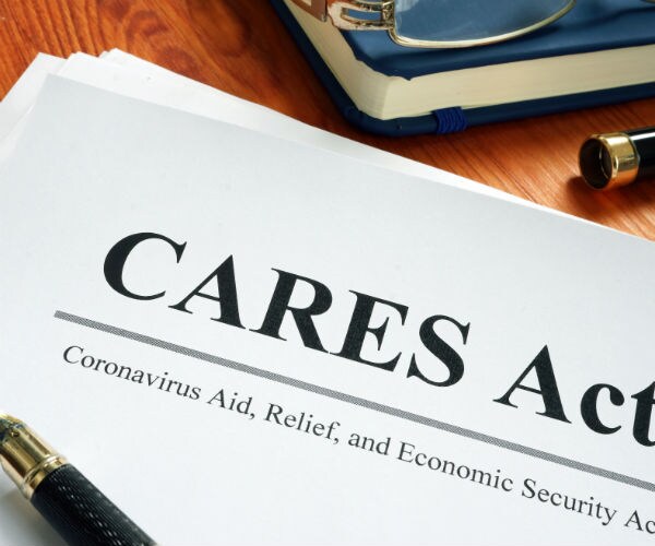 graphic shows the words cares act and coronavirus aid, relief and economic security in black on a white piece of paper 