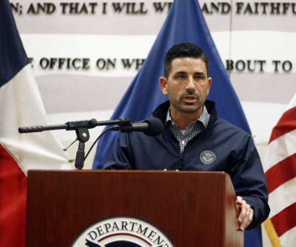 chad wolf standing a podium with homeland security logo on front and us flag in background 