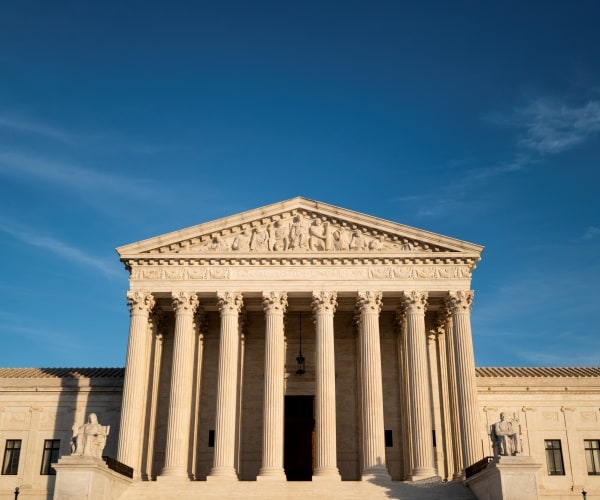 supreme court building is shown from outside against a blue sky