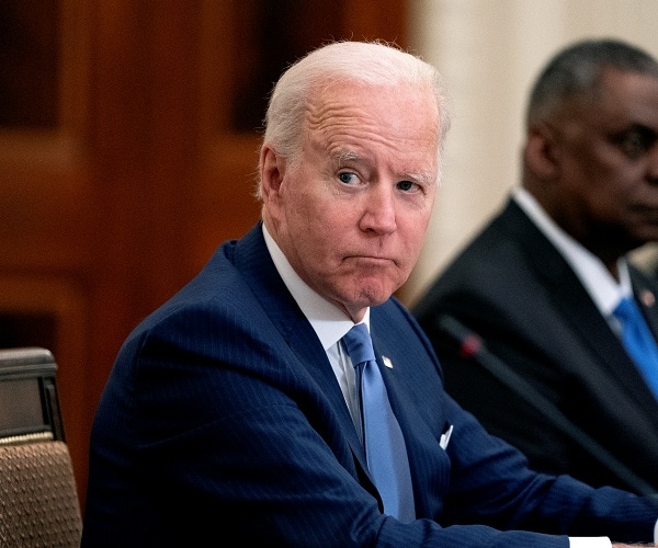 joe biden sits at dining table