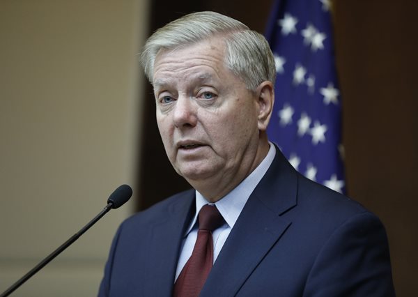 sen. lindsey graham speaking with american flag in background