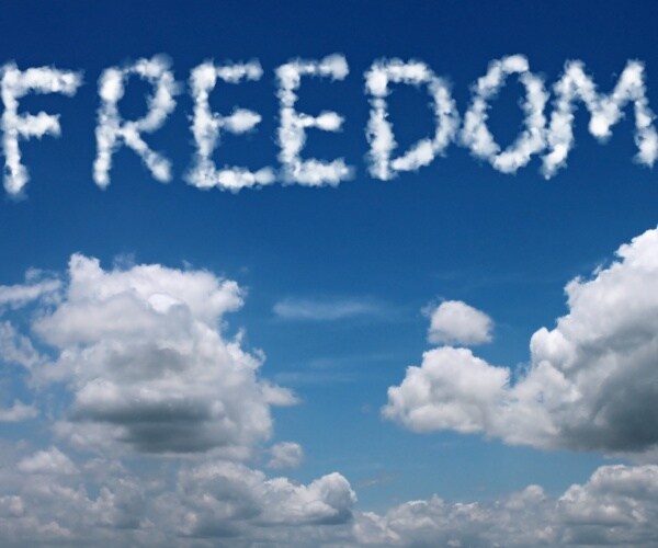 the word freedom written in cloud in the clear blue sky