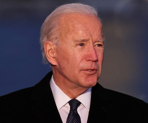 joe biden stands outside lincoln memorial