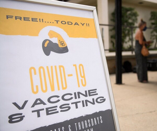 covid vaccine and testing sign