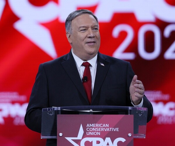 mike pompeo stands at a cpac podium and speaks