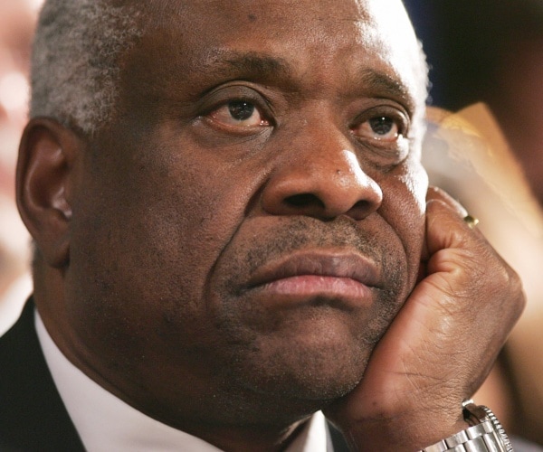 clarence thomas with his head resting on his hand