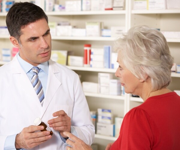 older woman talking to pharmacist about medication