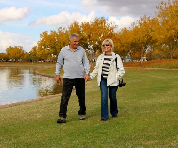 older couple walking together, holding hands