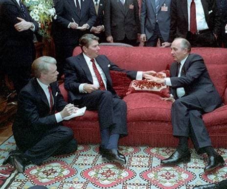 bill hopkins sits on the floor and ronald reagan and mikhail gorbachev sit on a couch