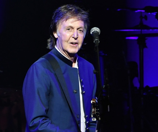 paul mccartney plays guitar onstage