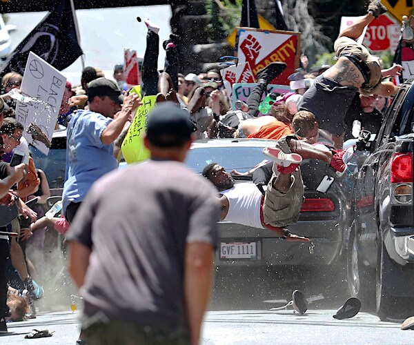 a car drives through a crowd